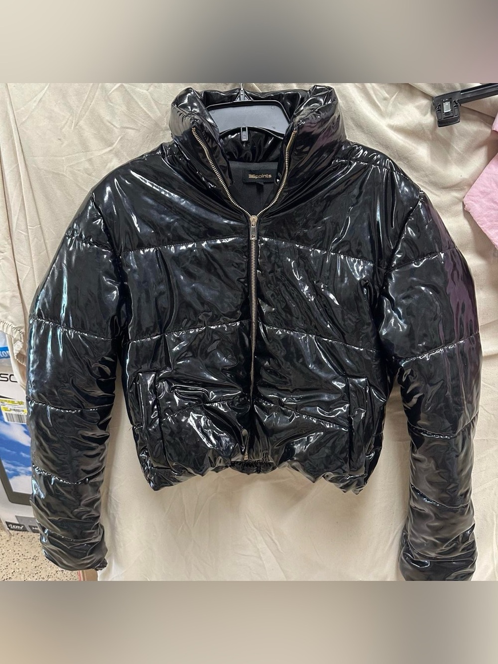 Black glossy puffy jacket.